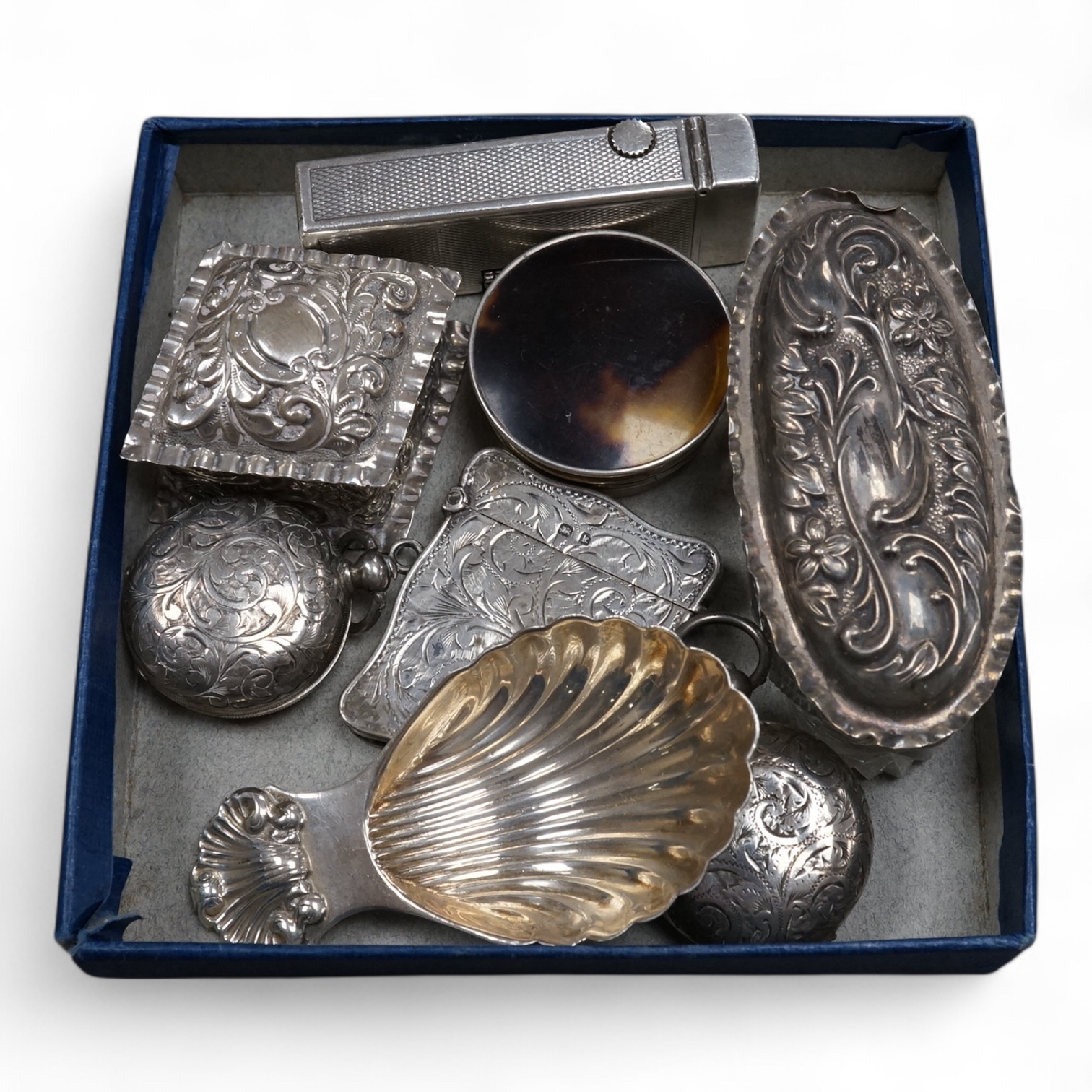 A Dunhill silver plated lighter and seven other items of collectable silver, including a modern silver caddy spoon by Pepper & Hope Ltd, a Victorian silver sovereign case, an Edwardian silver sovereign case, vesta case,